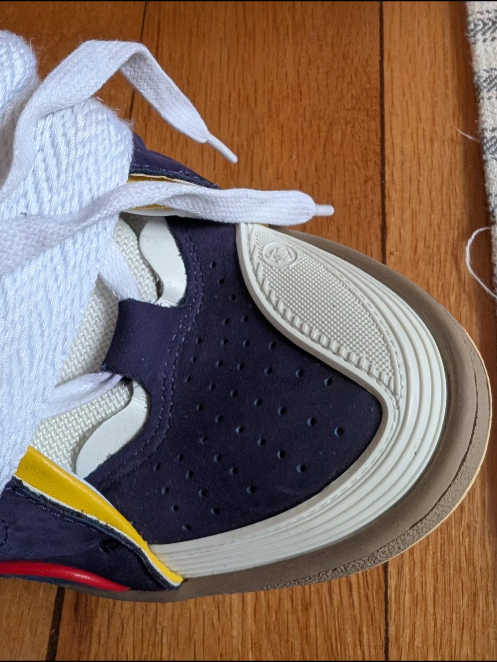 Lanvin Curb Sneakers in a distinct Navy Blue, White, Red, and Yellow colorway.